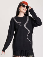 sweater with skeleton snake detail around neck.